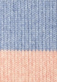 Knit fabric in light blue and soft pink, displaying a striped pattern with textured stitches. The yarn appears thick and fluffy.