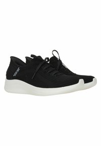 Zapatillas deportivas negras con una parte superior texturizada, que presentan un diseño con cordones y una suela blanca en contraste. Forma aerodinámica y materiales flexibles.