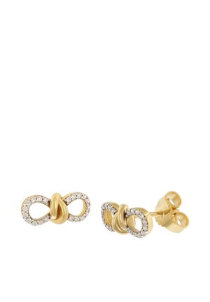 Gold stud earrings shaped like infinity symbols with small clear stones set along the loops and a smooth gold knot in the center.