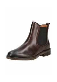 Botines de cuero marrón con paneles laterales elásticos, punta ligeramente afilada y tacón bajo apilado. Textura suave y diseño minimalista.