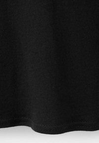 Close-up of the hem of a black knitted fabric garment, showing fine stitching and texture detail against a white background.