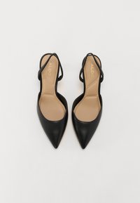 Black pointed-toe slingback shoes with a sleek leather upper and beige insole. Features thin ankle straps and a minimalist design.