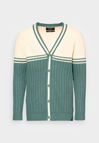 Cárdigan de punto con un diseño a bloques de color verde y crema. Escote en V, cierre de botones y textura acanalada con rayas en las mangas.