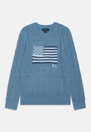 Gaiši zila adīta džemperis ar teksturētām kabelu rakstiem, ar izšūtu Amerikas karoga dizainu priekšpusē un ribotām piedurknēm.