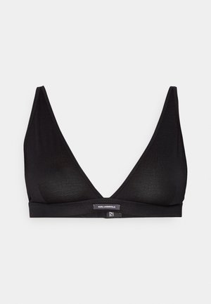 Zwarte bralette met een diepe V-halslijn, gemaakt van een gladde stof. Beschikt over een brede band en een subtiel logo aan de voorkant. Geen padding of beugel.