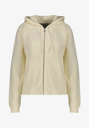 Krämfärgad zip-up hoodie med framfickor, snörning vid huva och ribbade ärmslut på en plain vit bakgrund.