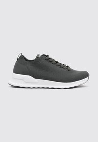 Zapatillas deportivas grises con parte superior de malla, suela blanca, punta redondeada y un diseño texturizado. Presentan cordones y un pequeño asa en la parte trasera.