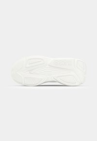 White sneaker sole featuring textured rubber with a wavy pattern and embossed logo. Smooth surface with varying tread designs for traction.