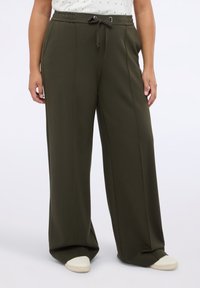 Vida byxor i olivgrön färg med vida ben, utrustade med resårmidja och dragsko, mjukt tyg och sidofickor.