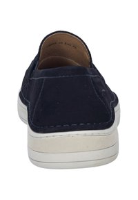 Navy suede slip-on shoes with white rubber sole. Features contrasting stitching and a rounded toe design. Interior lined with brown fabric.
