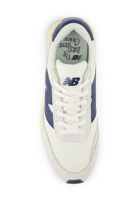 White and navy New Balance sneaker featuring mesh and suede materials, round toe, classic lacing, and branding on the tongue and side.