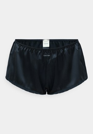 Schwarze Satinshorts mit elastischem Bund. Verfügt über ein Tag mit dem "Calvin Klein"-Logo in der Mitte der Vorderseite. Glatte Textur, standardmäßiger Schnitt.