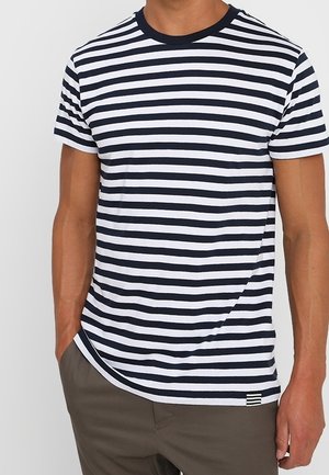 Short-sleeve t-shirt with navy and white horizontal stripes, round neckline, soft cotton material, and a small logo detail at the hem.