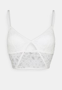 Bralette branco de renda com um design em V, alças finas e ajustáveis, e um detalhe recortado na parte da frente. Apresenta padrões de renda intricados.