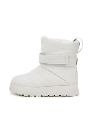 White padded ankle boot with a smooth leather exterior, elastic strap detail, and a thick, textured rubber sole. Features a loop for easy wear.