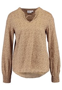 Blouse beige avec un motif floral, manches longues avec des poignets froncés et un décolleté en V. Tissu léger avec une texture douce.