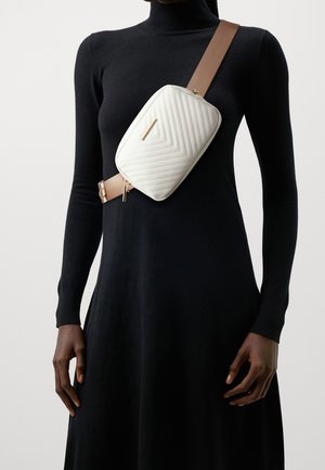 Quilted white synthetic crossbody bag with a rectangular shape and beige strap, featuring gold hardware and diagonal stitching patterns.