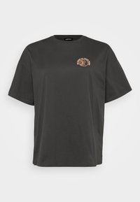 Schwarzes Baumwoll-T-Shirt mit übergroßer Passform, rundem Halsausschnitt und kurzen Ärmeln. Mit einem helloranfarbenen Druckmotiv auf der Brust.
