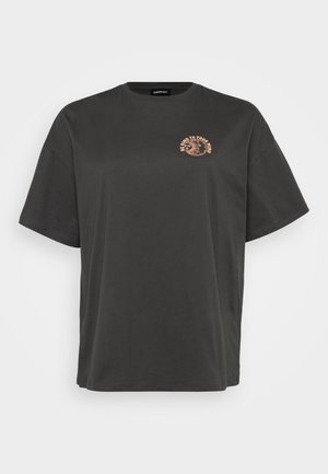 Black cotton t-shirt with oversized fit, round neckline, and short sleeves. Features a light orange printed graphic on the chest.