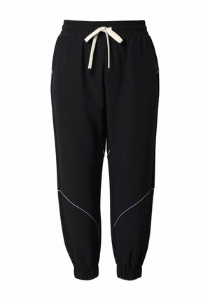 Schwarze Jogginghosen aus weichem Stoff, mit elastischem Bund und Kordelzug, seitlichen Ziernähten und verengten Bündchen.