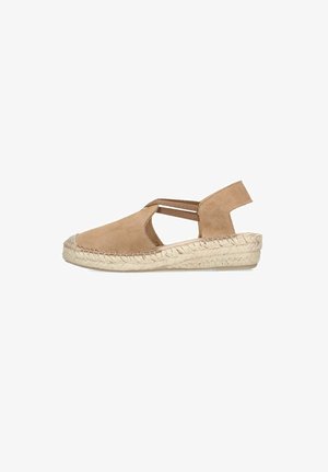 Tan suede closed-toe espadrille sandal with elastic straps and woven jute platform sole, side view on white background.