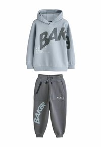 Gray hoodie with large black "BAKER" text, long sleeves, kangaroo pocket. Matching gray sweatpants with black accents and logo details.