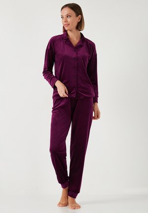 Velvet purple pajama set featuring a long-sleeve button-up top and matching pants with cuffs. Smooth texture, relaxed fit, no patterns.