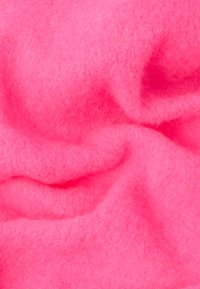Fleece fabric in bright pink with a soft, textured surface, showcasing gentle folds and slight variations in shade.