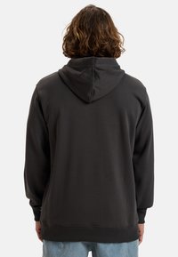 Dark gray hoodie, made of soft cotton blend, features a kangaroo pocket, ribbed cuffs, and a relaxed fit with a hood at the back.
