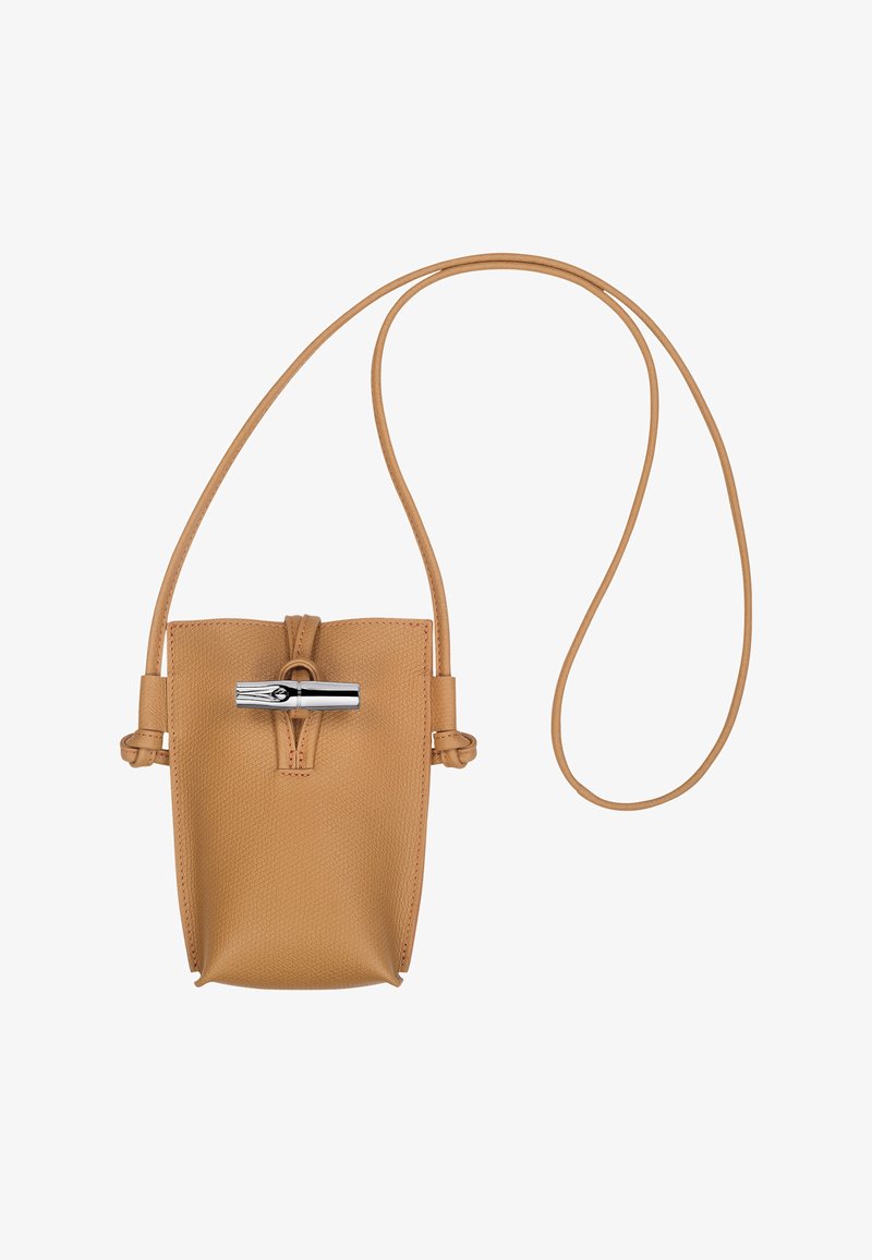 Tan leather handbag with a textured finish, featuring a silver toggle clasp and an adjustable strap. Compact design suitable for essentials.