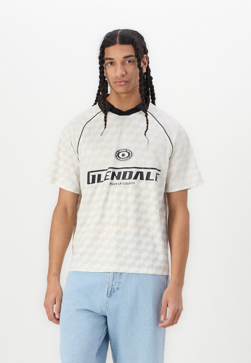 Short-sleeve t-shirt in cream with a checkered pattern, featuring a black collar and "GLENDALE" printed in bold black text.