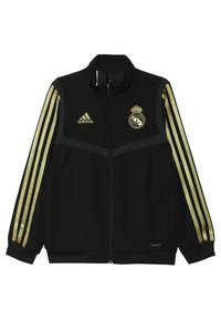 Black zip-up sports jacket with gold Adidas logo, gold Real Madrid emblem, and gold stripes on sleeves.