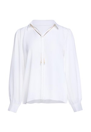 Blusa bianca a maniche lunghe con colletto e sottile fiocco decorativo con piccole perline simili a perle alle estremità.