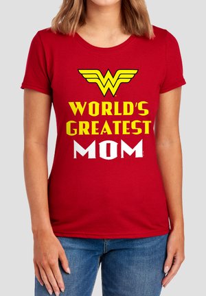 Woman wearing a red t-shirt with yellow Wonder Woman logo and text "World's Greatest Mom" in yellow and white letters.