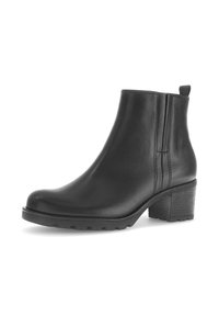 Zwarte leren enkelboot met een ronde neus, textuur op de zool en een blokhak van gemiddelde hoogte. Bevat subtiele stiksels en een trekband aan de achterkant.