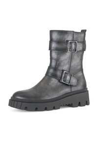 Black leather ankle boot with two adjustable strap buckles, chunky rubber sole, rounded toe, and textured finish.