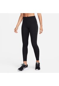 Czarne legginsy sportowe z wysokim stanem, z teksturowanym panelem bocznym ozdobionym małymi, odblaskowymi kropkami.