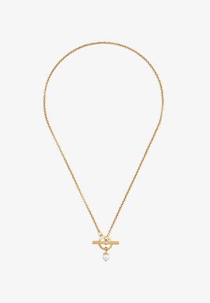 Kullatooniga kett-kaelakee, millel on ümmargune pandla kinnis ja üks valge pärli aksent. Kett on peene ja tekstuurse disainiga.