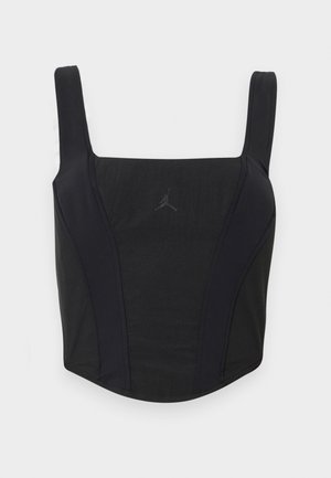 Débardeur court noir avec larges bretelles et logo subtil Jordan Jumpman centré sur la poitrine, sur fond uni.