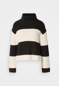 Pull à col roulé tricoté à larges rayures noires et blanches, manches longues et coupe décontractée.