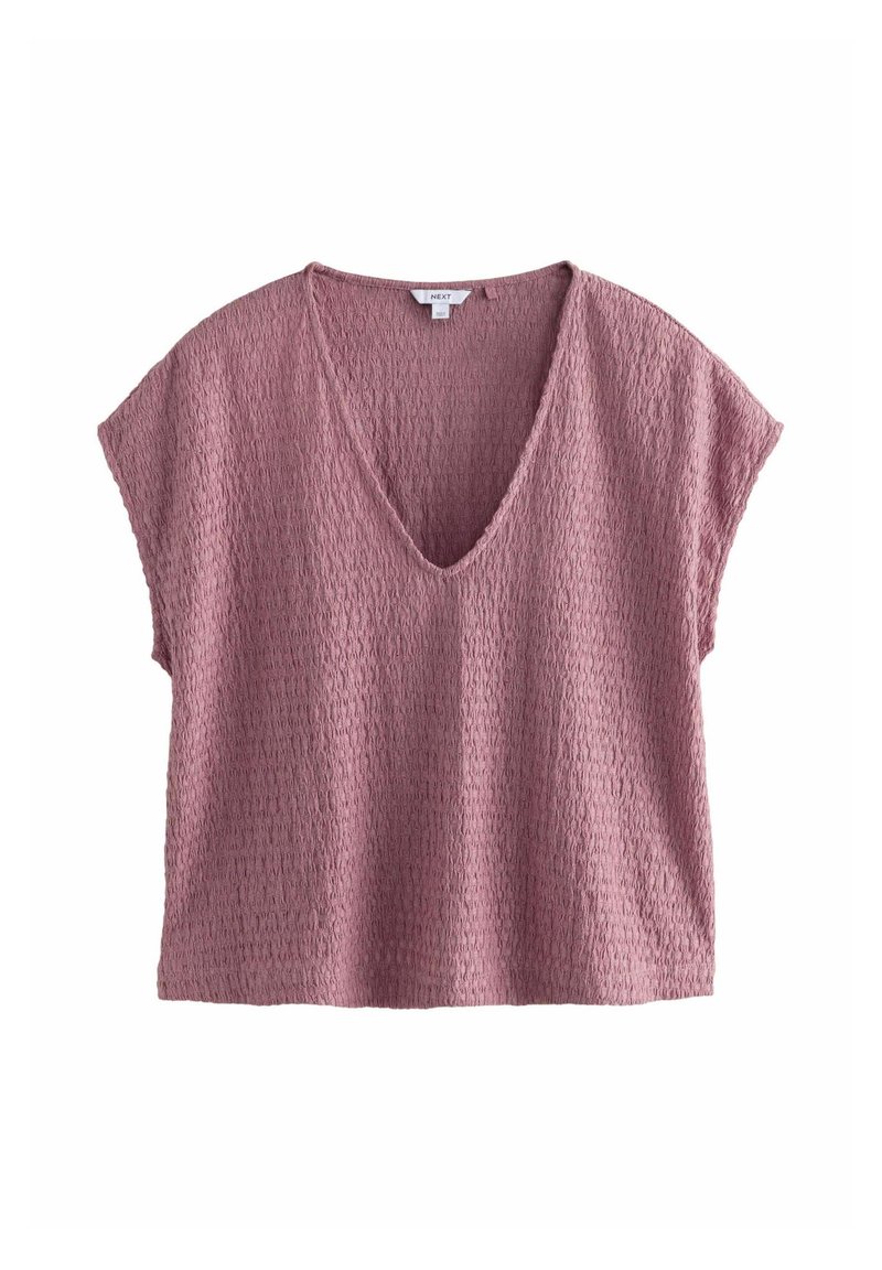 T-shirt à manches courtes, décolleté en V profond en tissu rose poussiéreux texturé. Présente une coupe ample et un matériau doux et respirant avec un motif subtil.