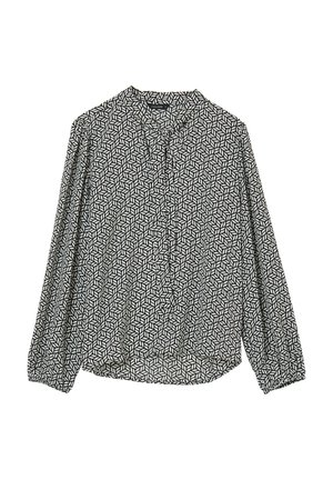 Blouse à manches longues noir et blanc avec un motif géométrique, devant à boutons, et en tissu doux. Comprend un col et des poignets froncés.