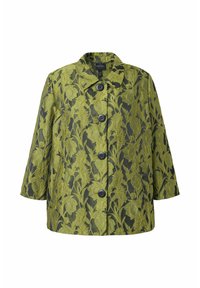 Manteau vert à motif floral avec des boutons noirs, manches trois-quarts et col pointu sur un fond sombre.