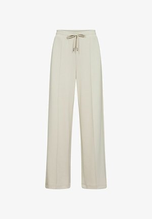 Ljust beige sweatpants med resårmidja och dragsko. Har sidoseam och en avslappnad, bred ben silhuett. Mjuk tygtextur.