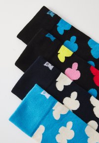 Four pairs of socks: black with blue accents, navy with pink, turquoise with white patterns, and cream with black, displaying various designs.