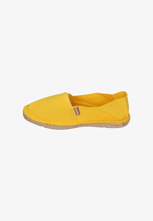 Yellow canvas slip-on shoe with a rounded toe and woven jute sole. Features stitched detailing and a small branded label on the side.