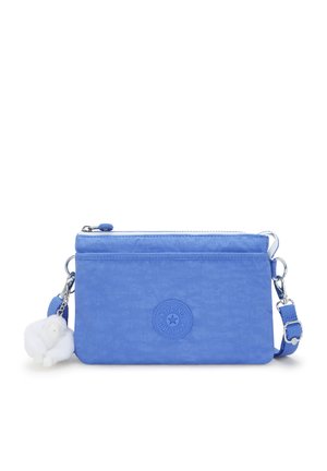 Blue nylon crossbody bag with a textured finish, featuring a zip closure, adjustable strap, and a white furry keychain accent.
