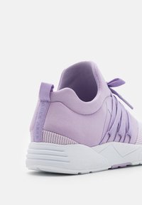 Light purple athletic shoe with a textured upper, elastic laces, and a white rubber sole featuring a ridged pattern at the heel.