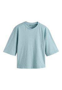 T-shirt bleu clair à manches courtes oversize avec col rond, en tissu de coton doux, présenté sur fond blanc.