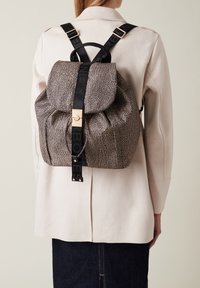Zaino texturizzato khaki e nero con chiusura a coulisse e accessori in oro, dotato di spallacci regolabili con branding stampato.